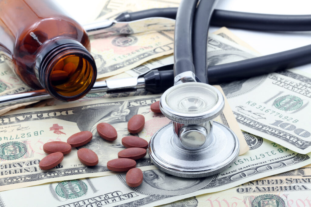 Stethoscope and Pills on dollars