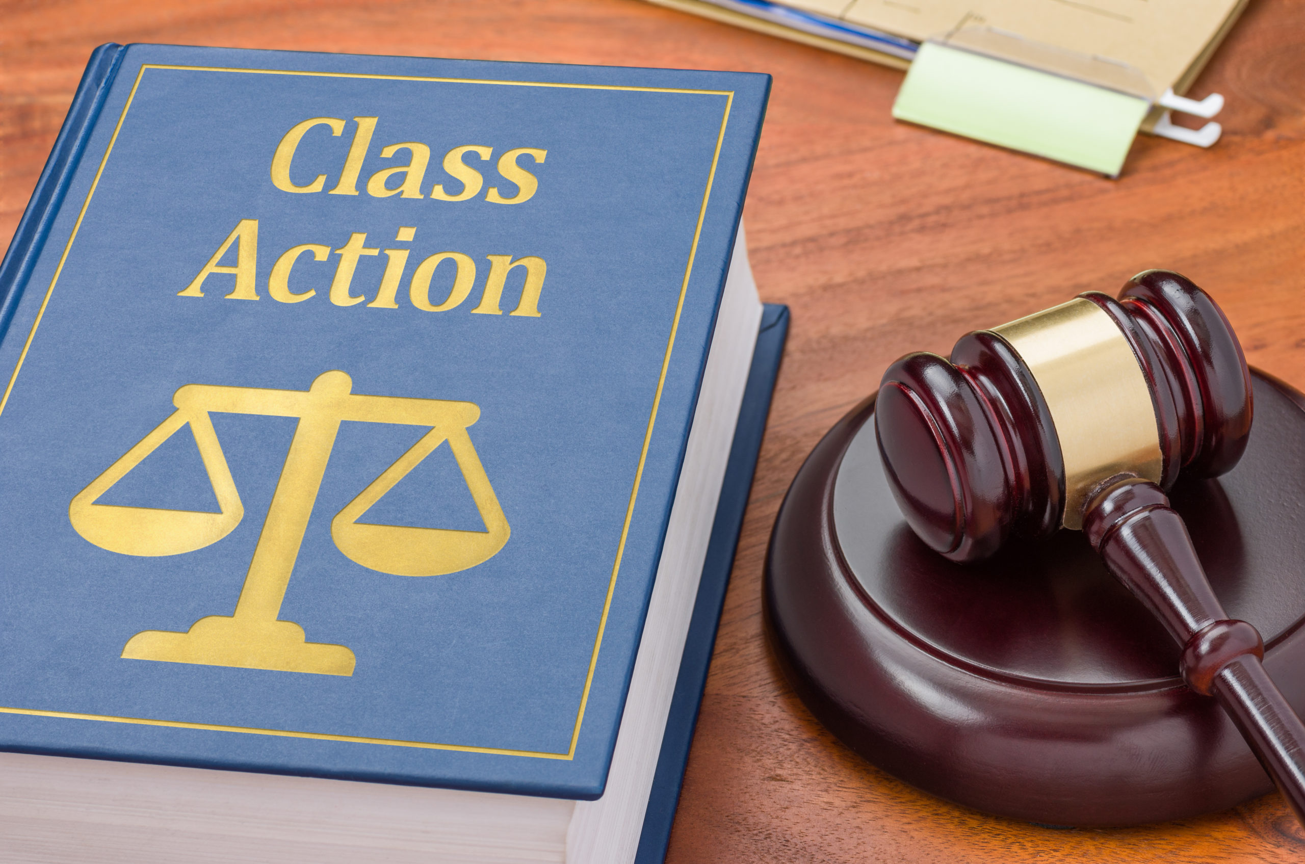 A law book with a gavel – Class action