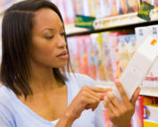 Female shopper checking food labelling in supermarket