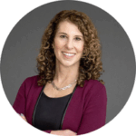 Mayl, Sharon_round Headshot of a man smiling. He has black hair, and is wearing a suit, white shirt, and red tie.